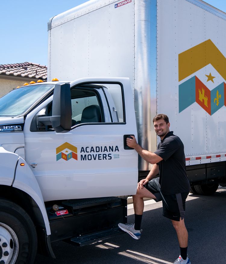 Man standing by Acadiana Movers truck